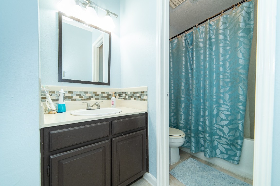 4866 Milwee Street, Unit 22 Houston, TX 77092 - Photo 11 of 23 a bathroom with a sink and a mirror