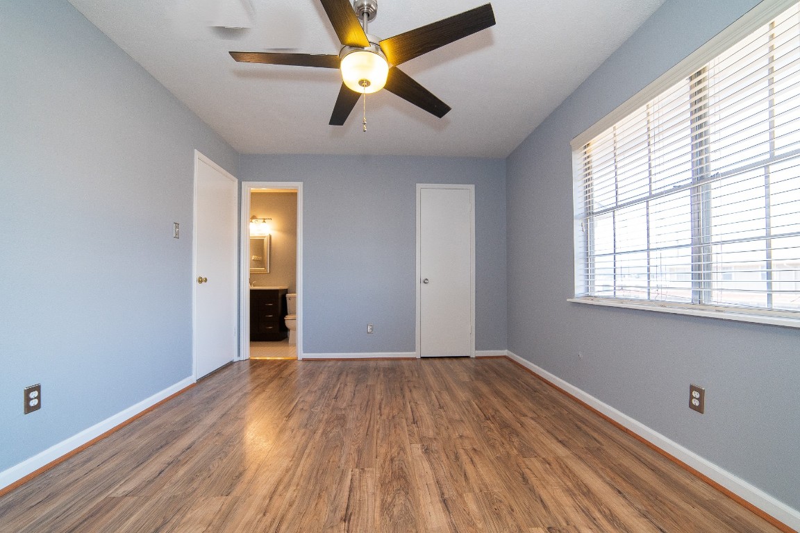 4866 Milwee Street, Unit 22 Houston, TX 77092 - Photo 13 of 23 wooden floor in an empty room with a window