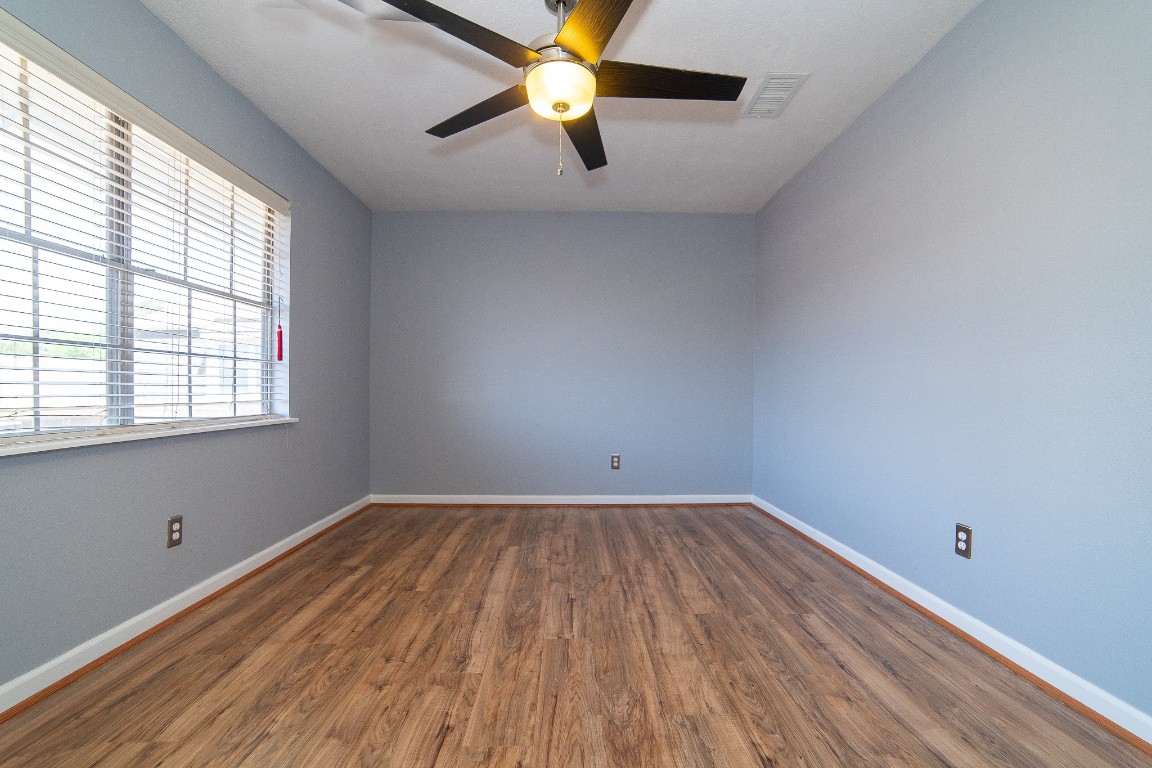 4866 Milwee Street, Unit 22 Houston, TX 77092 - Photo 14 of 23 wooden floor in an empty room with a window