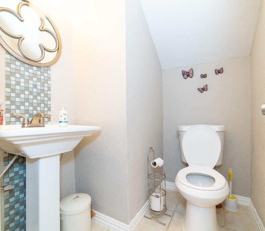4866 Milwee Street, Unit 22 Houston, TX 77092 - Photo 18 of 23 a bathroom with a sink a toilet and a mirror