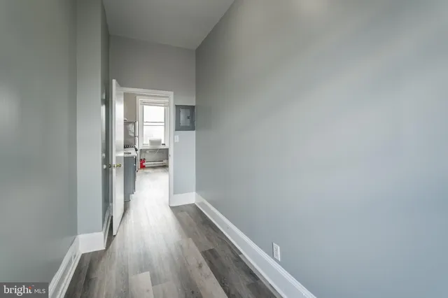 a view of a room with wooden floor