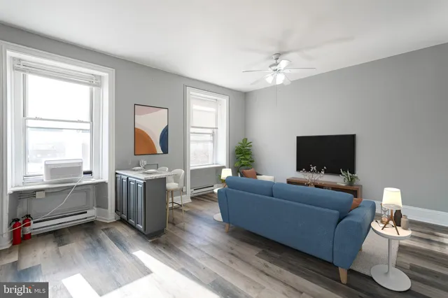a living room with furniture and a flat screen tv