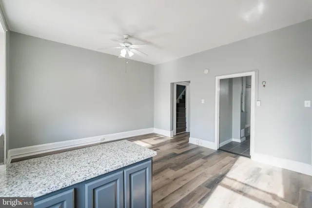 a view of an empty room and kitchen space