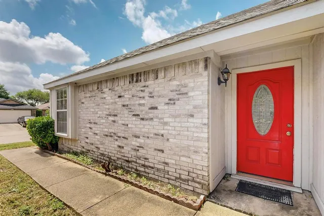 an aerial view of a house with a yard and lake view