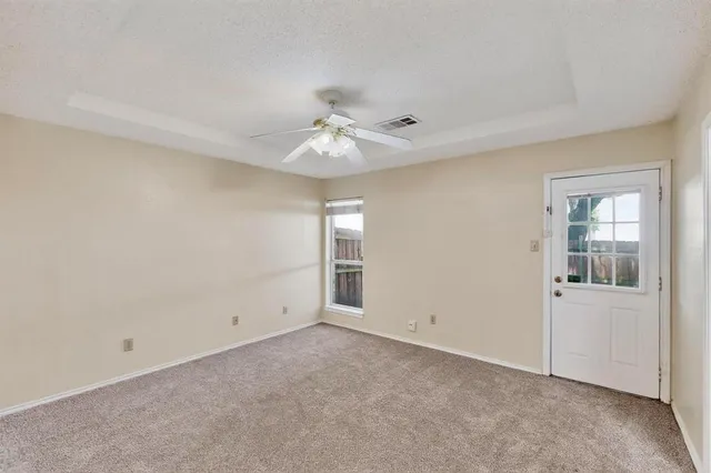 a kitchen with granite countertop a sink a counter top space and cabinets
