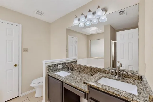 a kitchen with stainless steel appliances a counter top space cabinets and a wooden floor