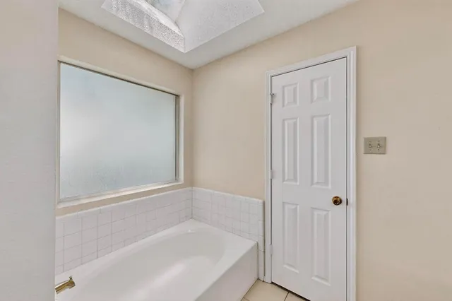 a view of a kitchen with kitchen island granite countertop a refrigerator and a stove top oven