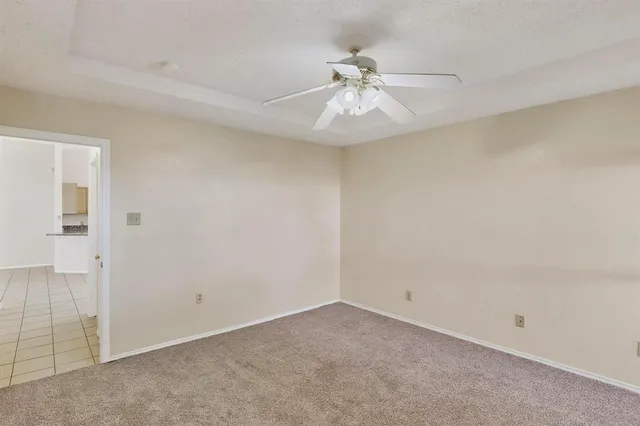 a bathroom with a granite countertop sink a toilet and a mirror