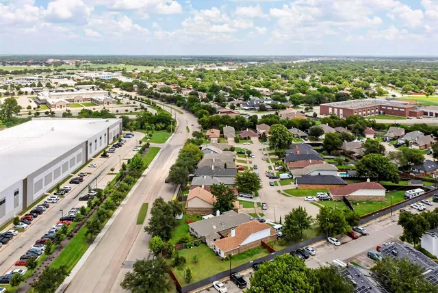 an aerial view of multiple houses with yard