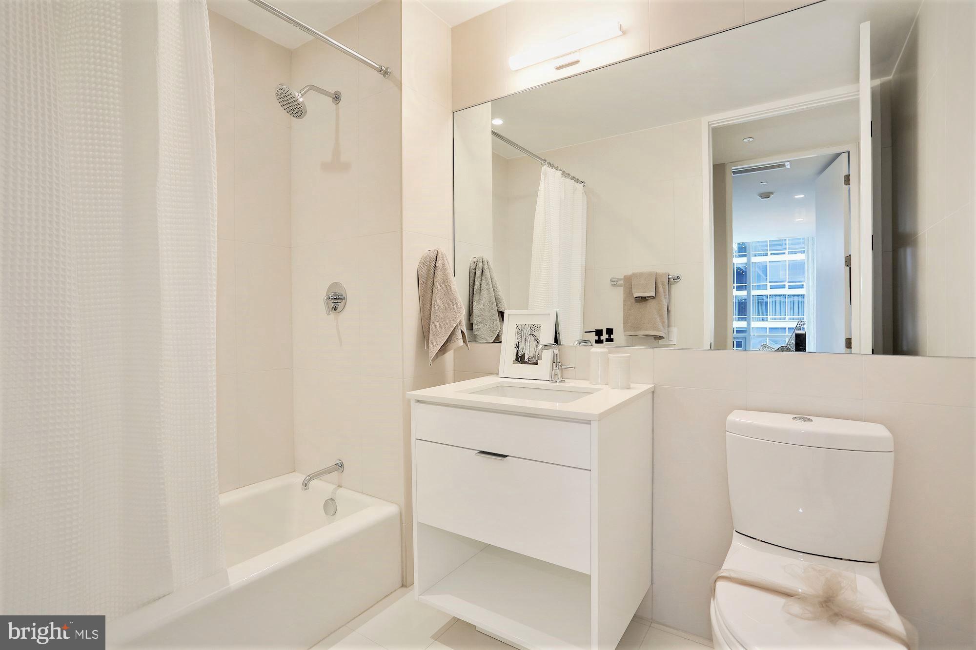1111 24th Street Northwest, Unit 81 Washington, DC 20037 - Photo 12 of 19 a bathroom with a sink a toilet and a bathtub