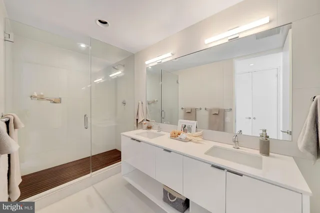 a bathroom with a sink double vanity and a mirror