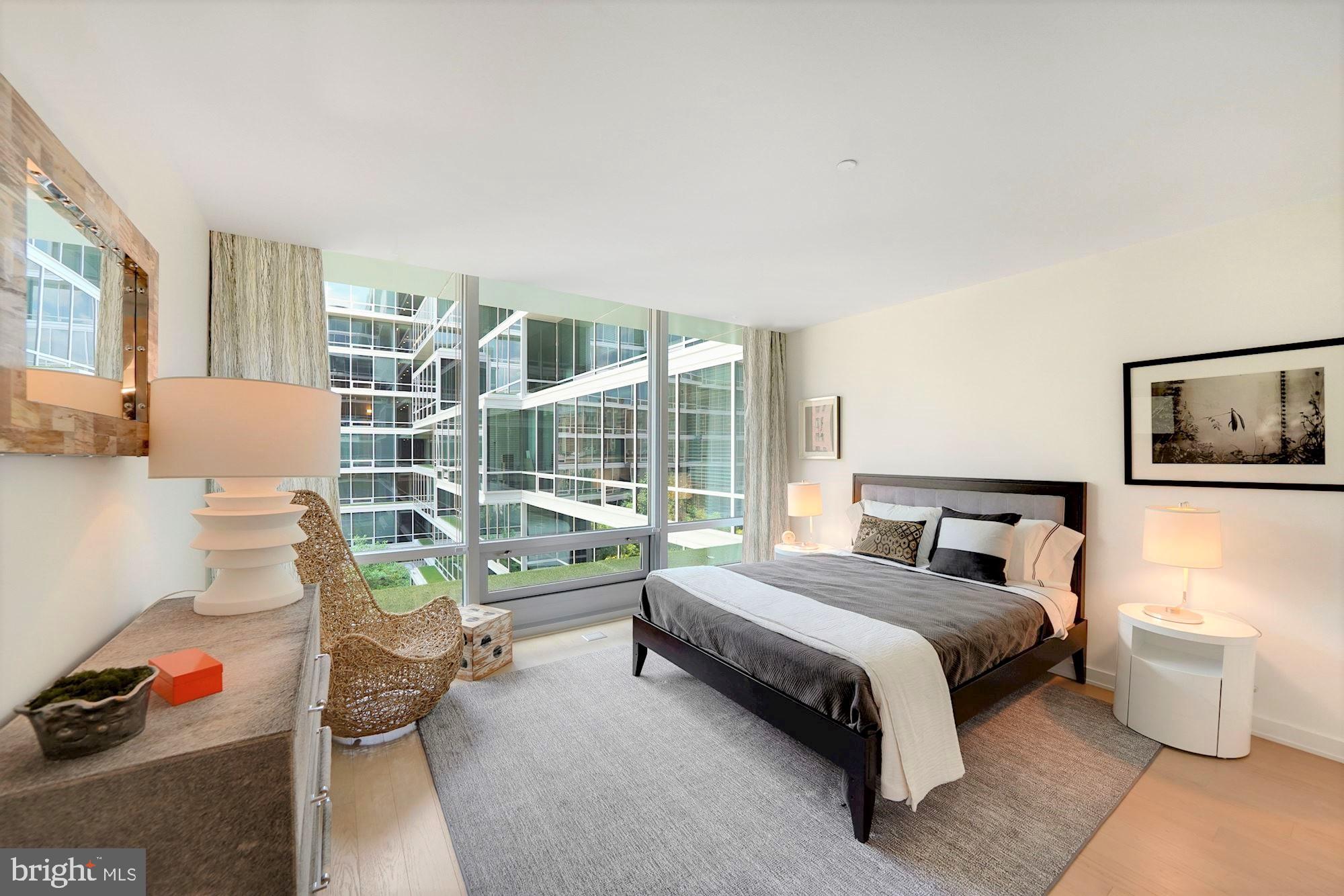 1111 24th Street Northwest, Unit 81 Washington, DC 20037 - Photo 9 of 19 a bedroom with a bed and a couch