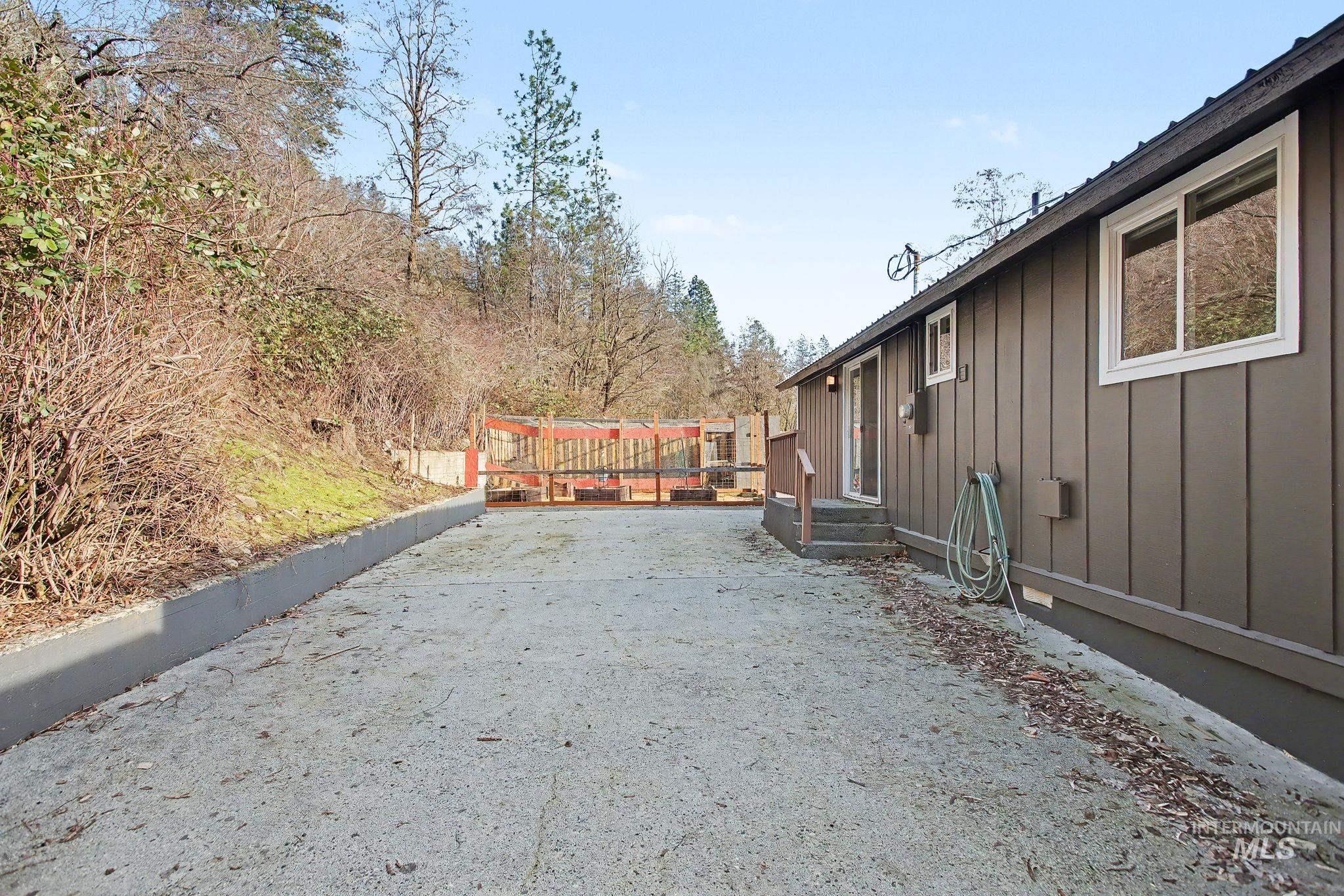 150 Elm Street Orofino, ID 83544 - Photo 28 of 36 Exterior of a single-story residence featuring vertical board siding and white-framed windows