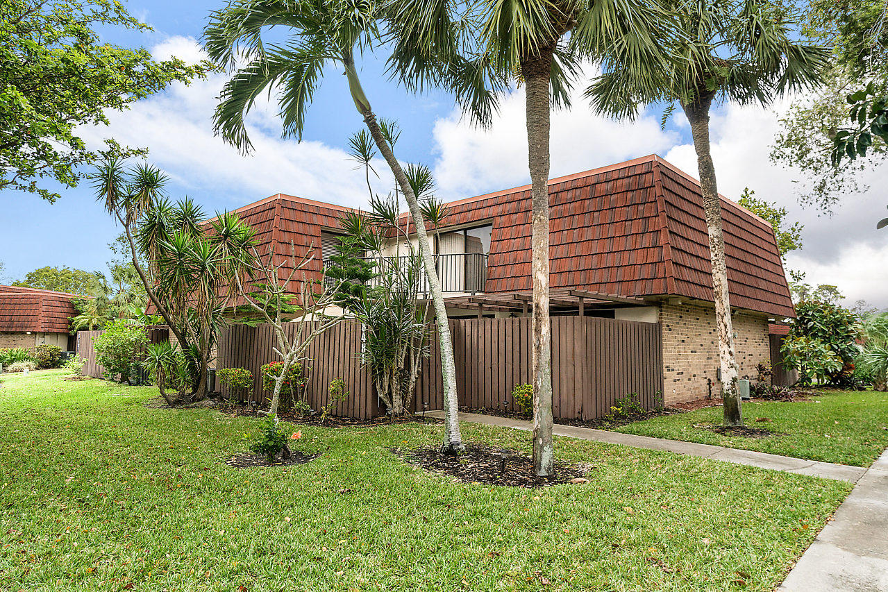 8481 Boca Rio Drive Boca Raton, FL 33433 - Photo 1 of 27 a backyard of a house with palm trees