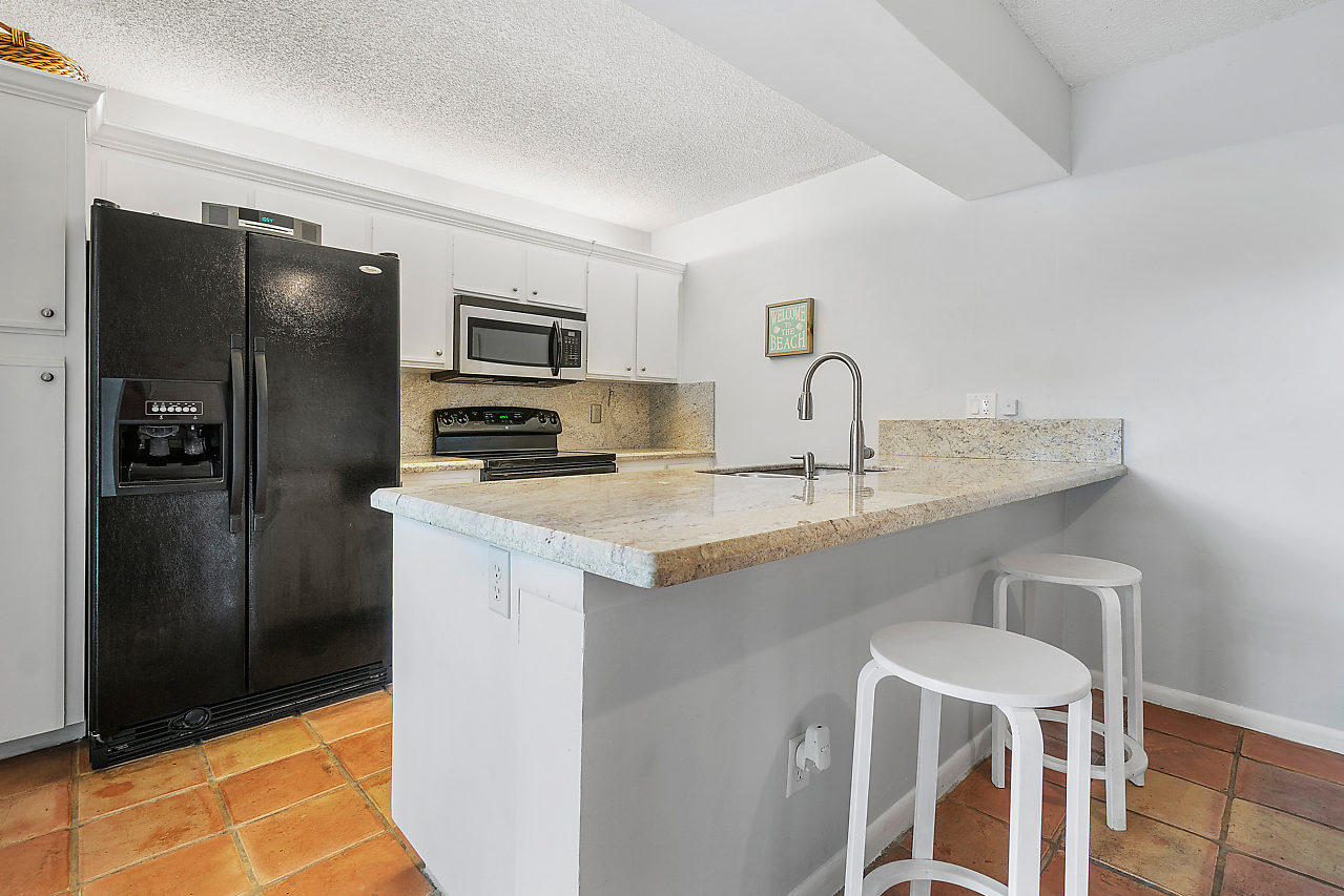8481 Boca Rio Drive Boca Raton, FL 33433 - Photo 11 of 27 a kitchen with stainless steel appliances granite countertop a refrigerator and a stove top oven