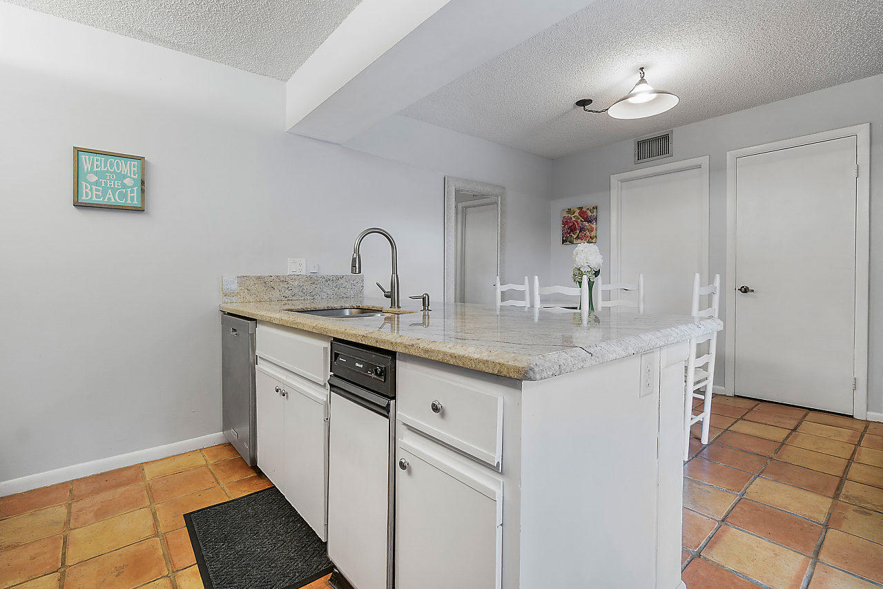 8481 Boca Rio Drive Boca Raton, FL 33433 - Photo 12 of 27 a kitchen with stainless steel appliances granite countertop a sink and dishwasher