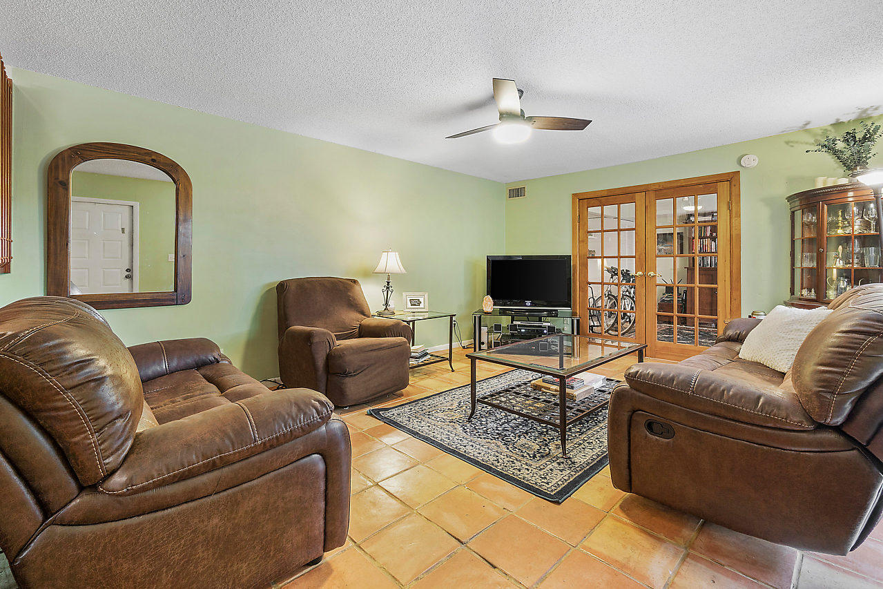 8481 Boca Rio Drive Boca Raton, FL 33433 - Photo 15 of 27 a living room with furniture ceiling fan and a flat screen tv