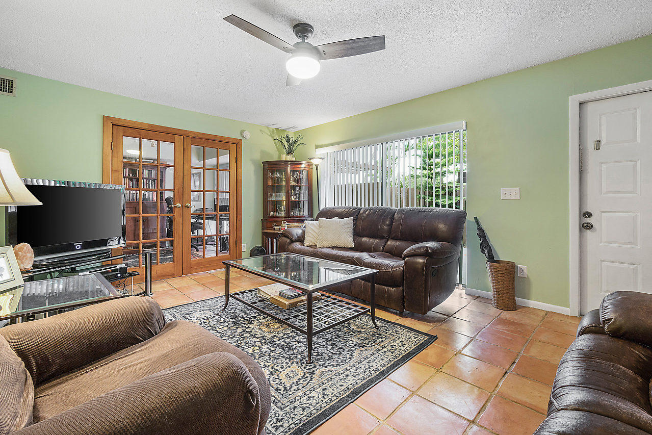 8481 Boca Rio Drive Boca Raton, FL 33433 - Photo 16 of 27 a living room with furniture and a flat screen tv