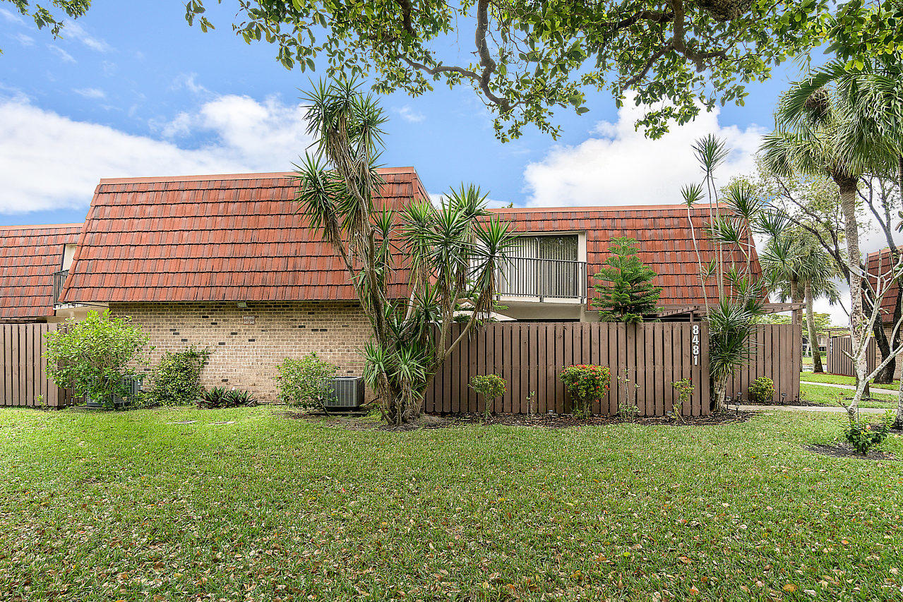 8481 Boca Rio Drive Boca Raton, FL 33433 - Photo 2 of 27 a front view of a house with garden