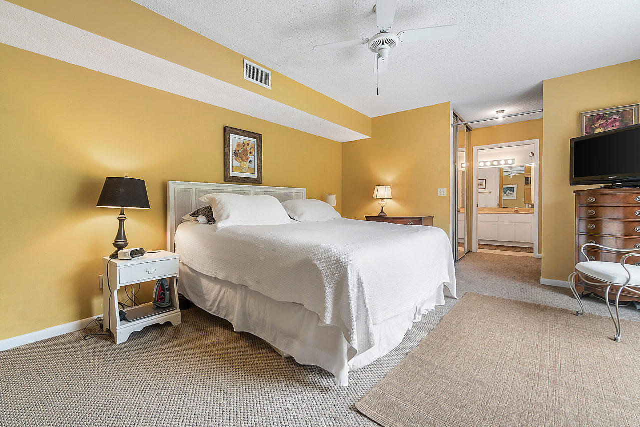 8481 Boca Rio Drive Boca Raton, FL 33433 - Photo 21 of 27 a bedroom with a bed and a chair