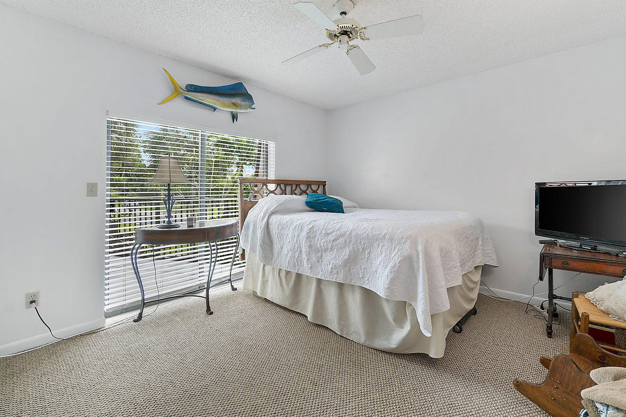8481 Boca Rio Drive Boca Raton, FL 33433 - Photo 23 of 27 a bedroom with a bed and a flat screen tv