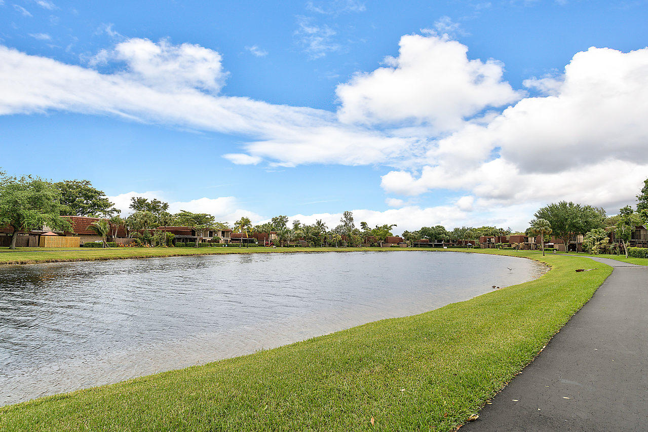 8481 Boca Rio Drive Boca Raton, FL 33433 - Photo 3 of 27 a view of a lake with houses in the back