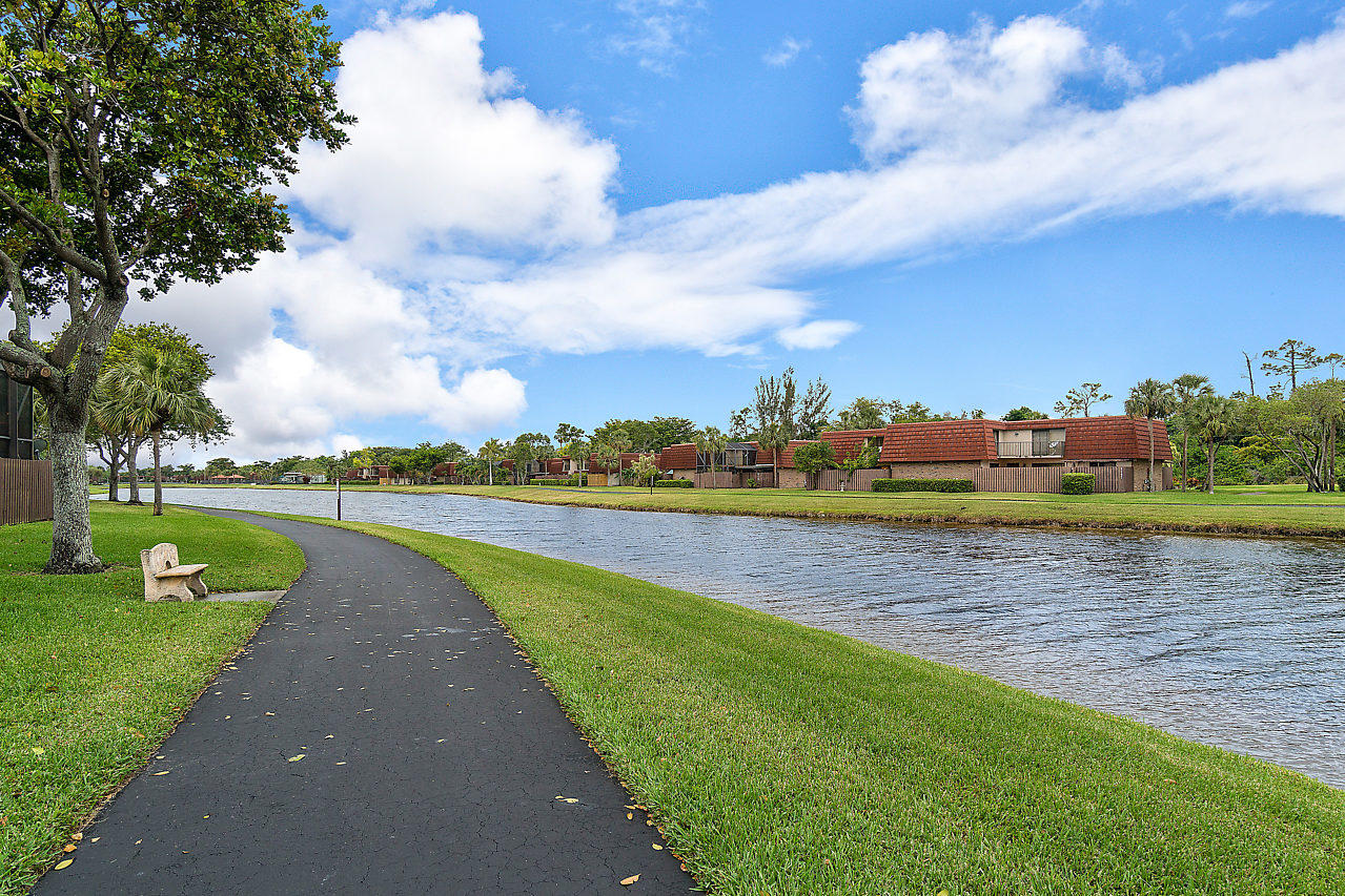8481 Boca Rio Drive Boca Raton, FL 33433 - Photo 4 of 27 a view of a lake with houses in the back