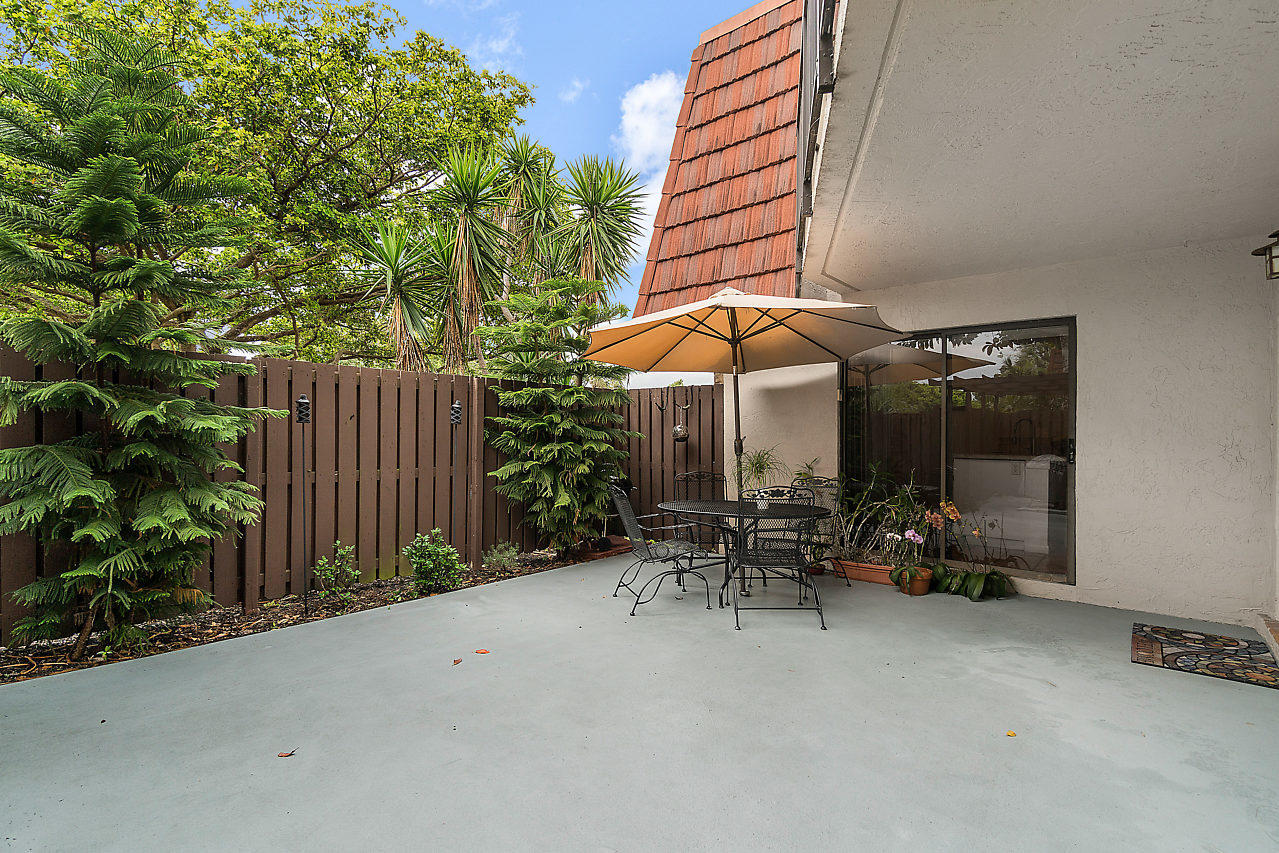 8481 Boca Rio Drive Boca Raton, FL 33433 - Photo 6 of 27 an outdoor space with patio and white umbrellas