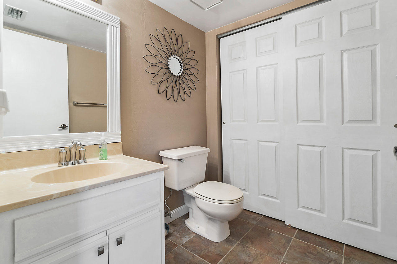 8481 Boca Rio Drive Boca Raton, FL 33433 - Photo 8 of 27 a bathroom with a sink a toilet and vanity
