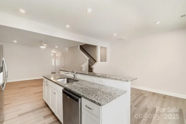 a kitchen with a sink and a mirror