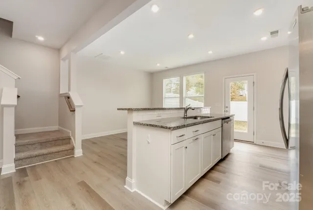 a bathroom with granite countertop a sink and a mirror
