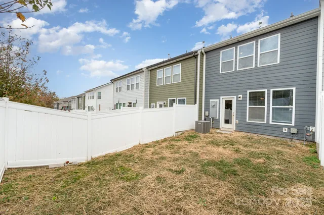 a front view of a house with a large tree