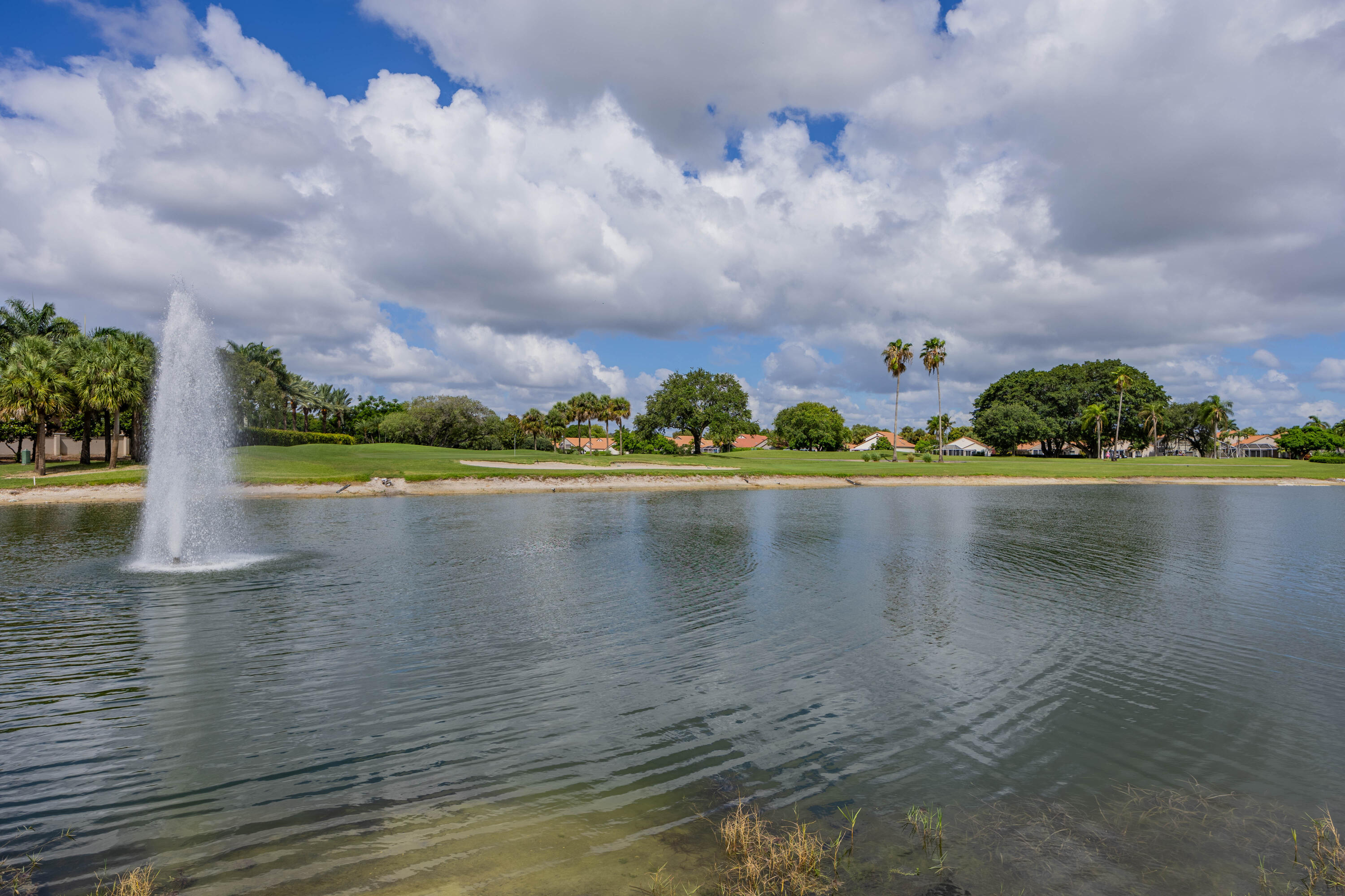 7520 La Paz Boulevard, Unit 104 Boca Raton, FL 33433 - Photo 53 of 56 a view of a lake with houses in the back