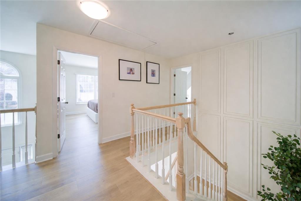 745 Welford Road Northwest Suwanee, GA 30024 - Photo 15 of 32 a view of a hallway with wooden floor and windows