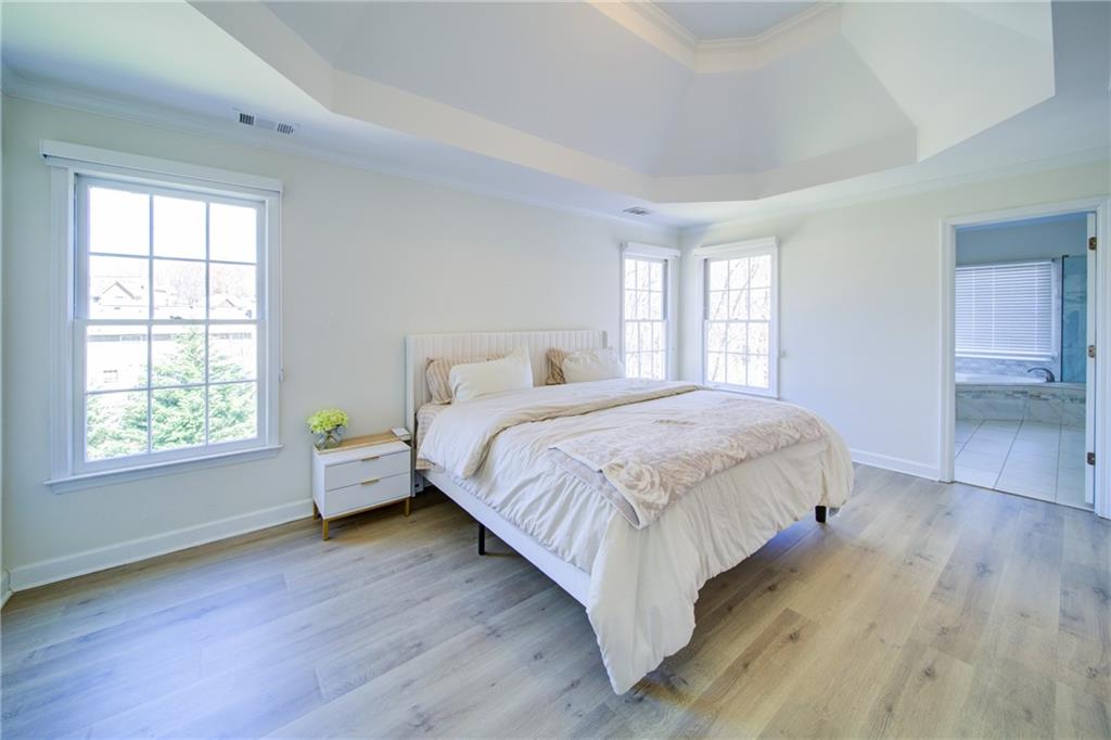 745 Welford Road Northwest Suwanee, GA 30024 - Photo 21 of 32 a bedroom with a bed and window