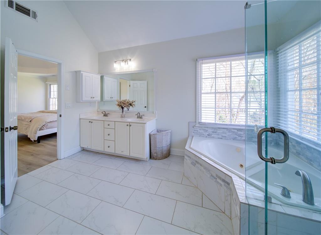745 Welford Road Northwest Suwanee, GA 30024 - Photo 23 of 32 a en suite bathroom with a double vanity sink and a mirror