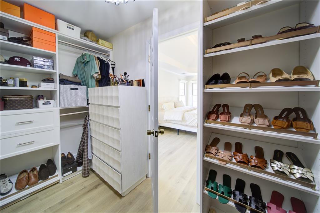 745 Welford Road Northwest Suwanee, GA 30024 - Photo 24 of 32 a view of walk in closet with clothes and shoes