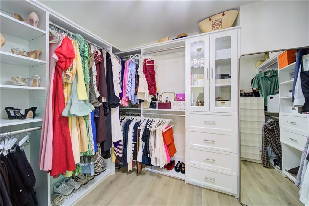 745 Welford Road Northwest Suwanee, GA 30024 - Photo 25 of 32 a view of walk in closet with clothes