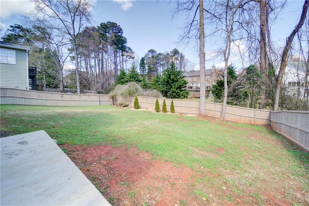 745 Welford Road Northwest Suwanee, GA 30024 - Photo 30 of 32 a view of a backyard with large trees