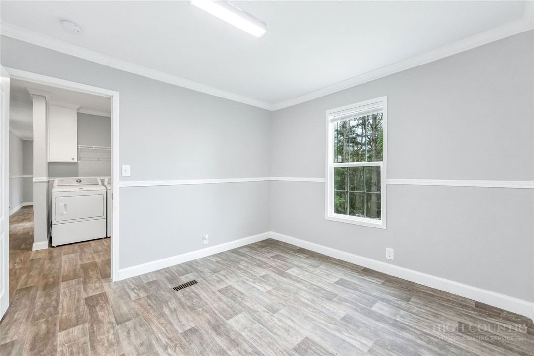 939 Don Bare Road Jefferson, NC 28640 - Photo 41 of 49 an empty room with wooden floor and windows