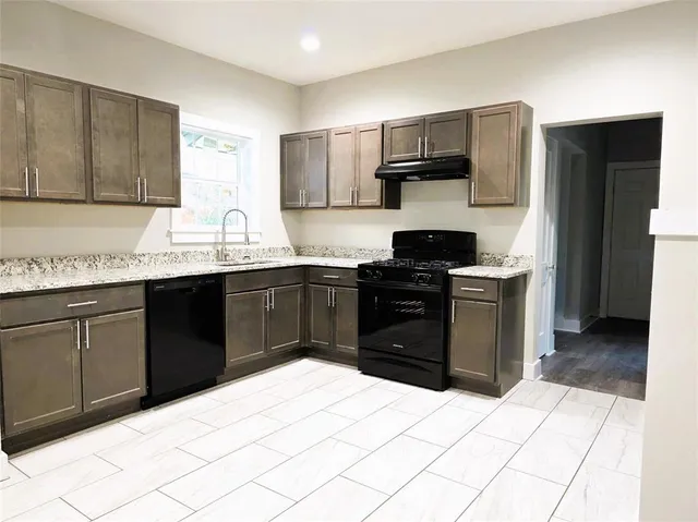 a kitchen with a sink and a stove