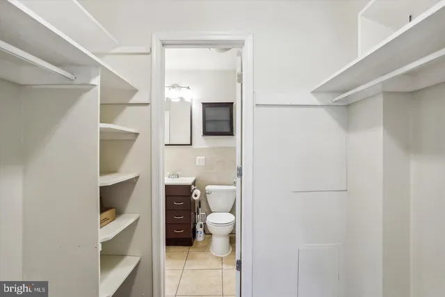 a kitchen with granite countertop a sink a stove and cabinets