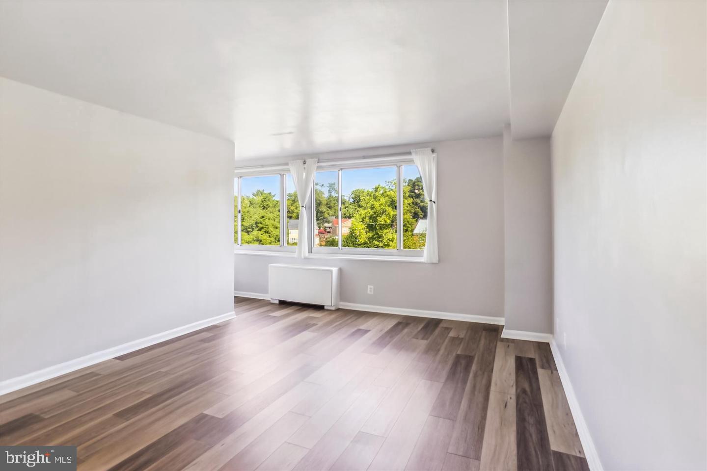 1900 Lyttonsville Road, Unit 602 Silver Spring, MD 20910 - Photo 5 of 43 an empty room with window and wooden floor