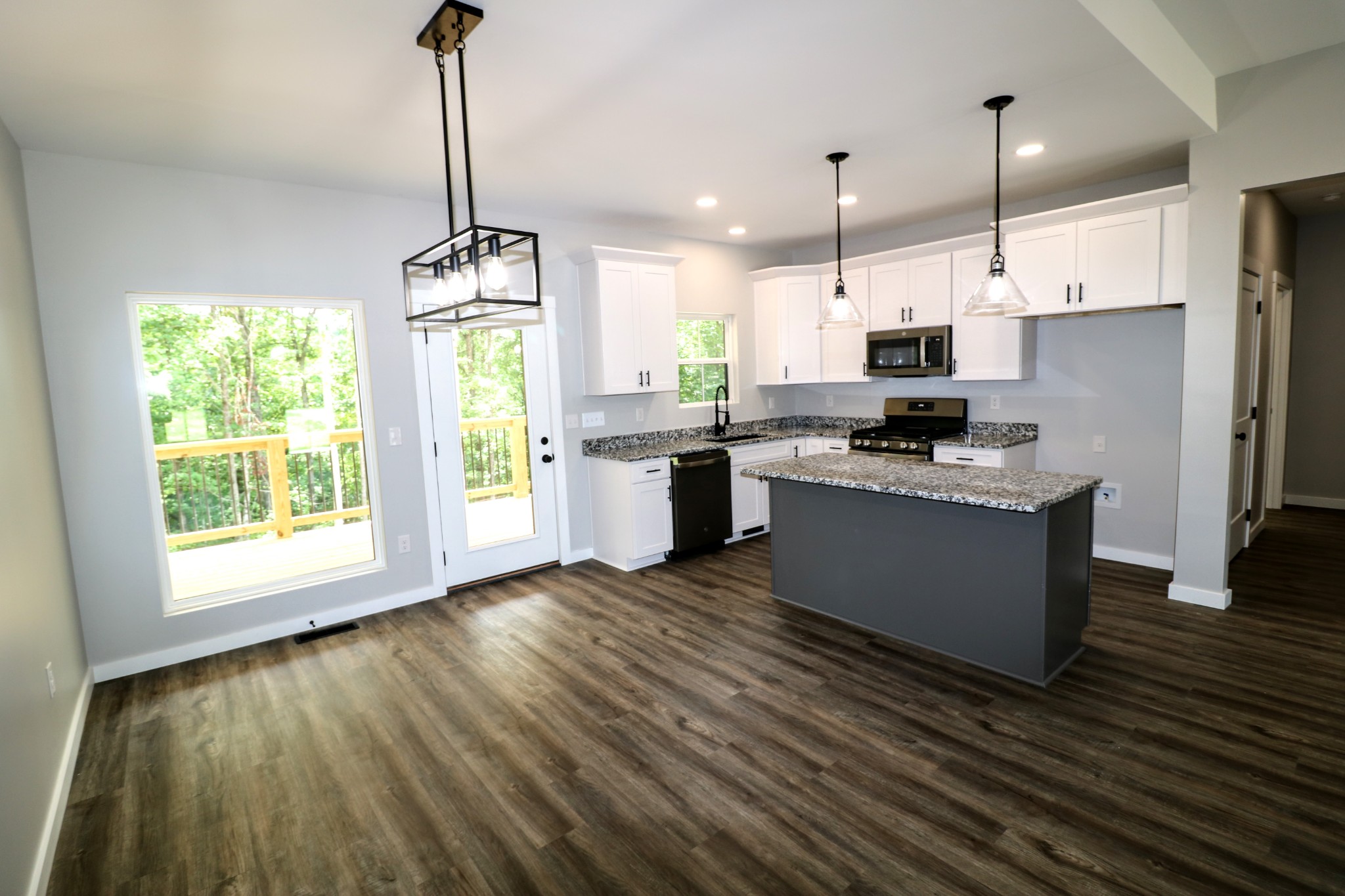 2775 Mayne Trace Road Waverly, TN 37185 - Photo 15 of 43 a kitchen with stainless steel appliances granite countertop a sink a stove a refrigerator cabinets and wooden floor