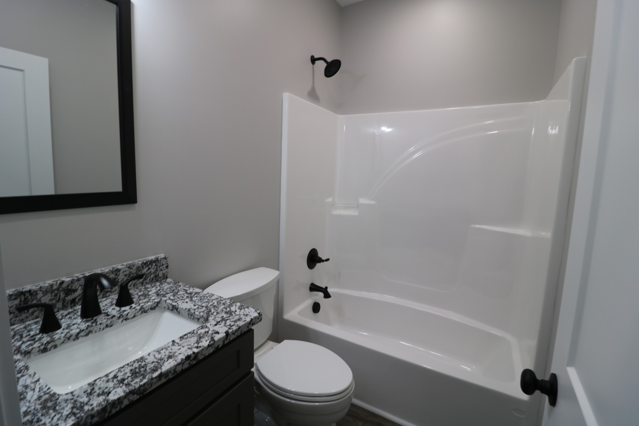 2775 Mayne Trace Road Waverly, TN 37185 - Photo 35 of 43 a bathroom with a granite countertop sink toilet a mirror and shower