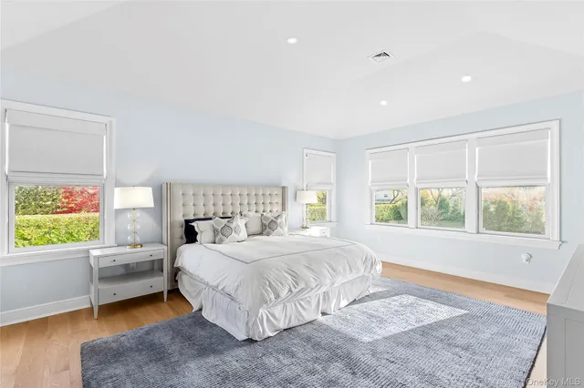 a bedroom with a large bed and a window