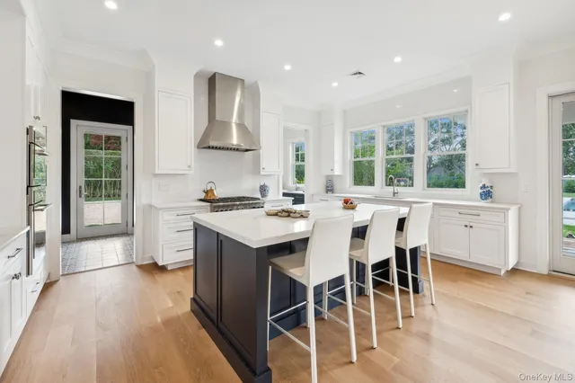 a kitchen with stainless steel appliances kitchen island granite countertop a stove a sink and a refrigerator