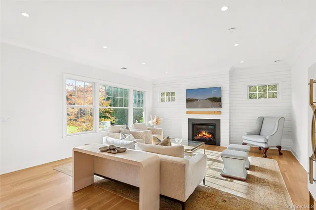 a living room with furniture fireplace and window