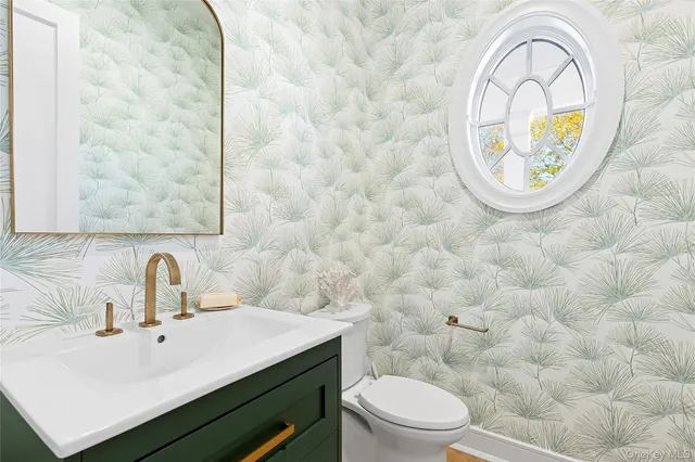 a bathroom with a sink a mirror and a toilet