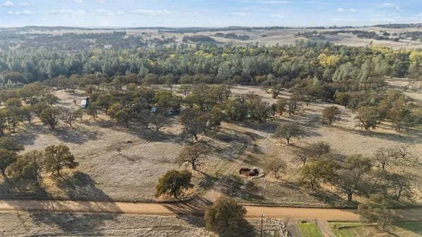 a view of a field with mountains in the background